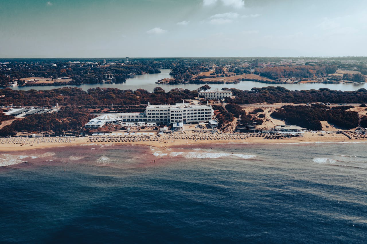 Discover the stunning coastal landscape of Sabaudias beachfront hotels under a clear summer sky.