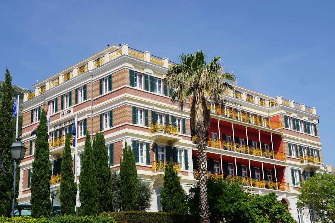 Stunning exterior view of the Hilton Imperial Hotel with vibrant balconies in Dubrovnik.